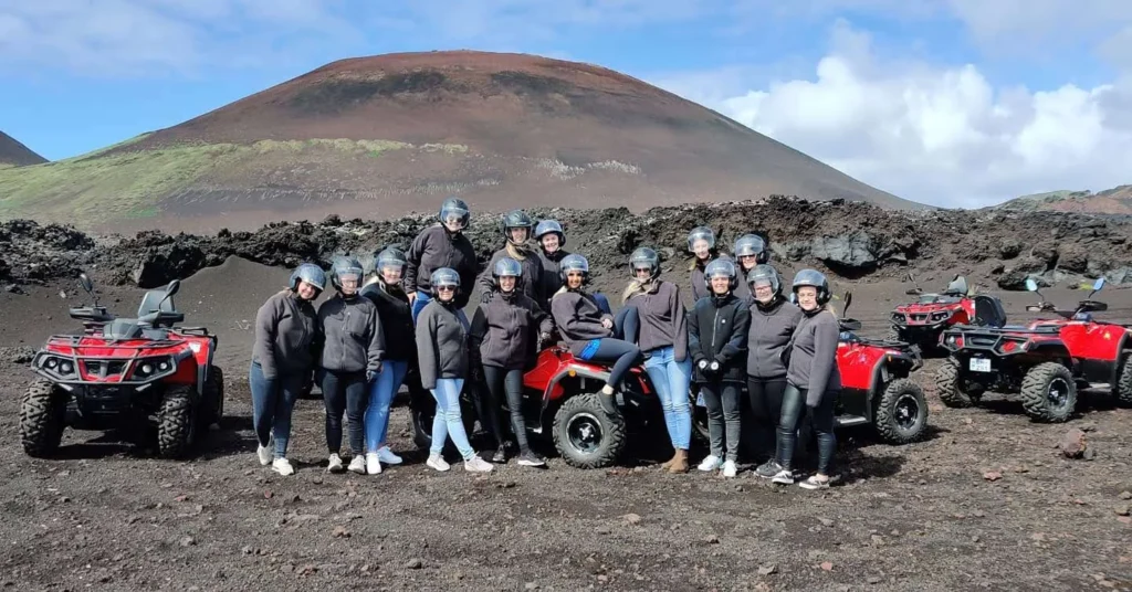 Guests and ATVs beneath Eldfell
